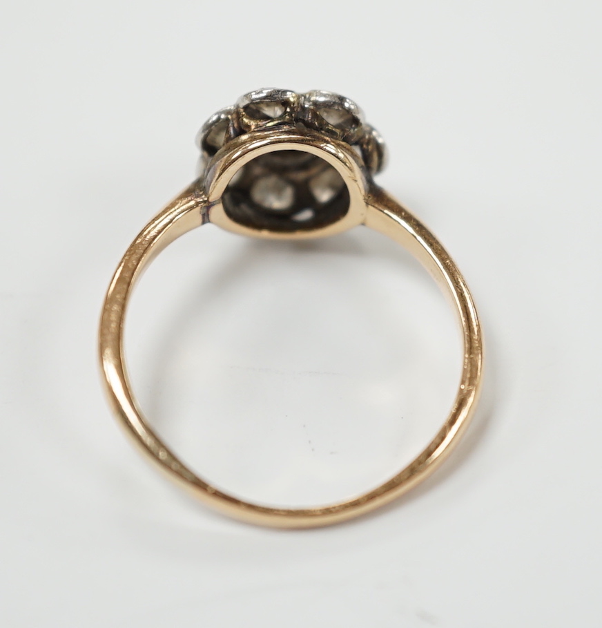 A yellow metal eight stone diamond cluster ring, size N